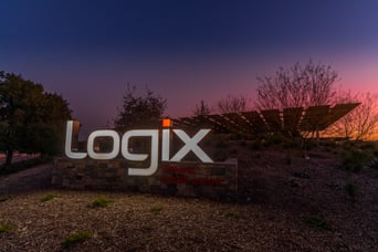 Logix federal credit union headquarters sign, lit up at sundown with sunset in background