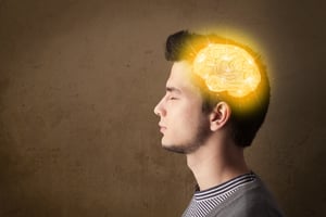 Young man thinking with glowing brain illustration